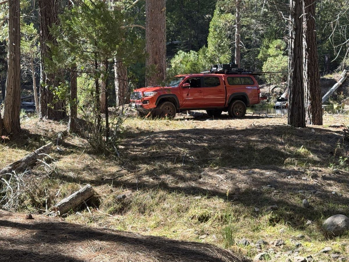 Orange Tacoma TRD 4x4 with roof rack at the campsite